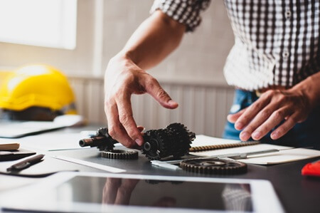 Engineer working with a prototype for a CNC small batch production manufacturing run